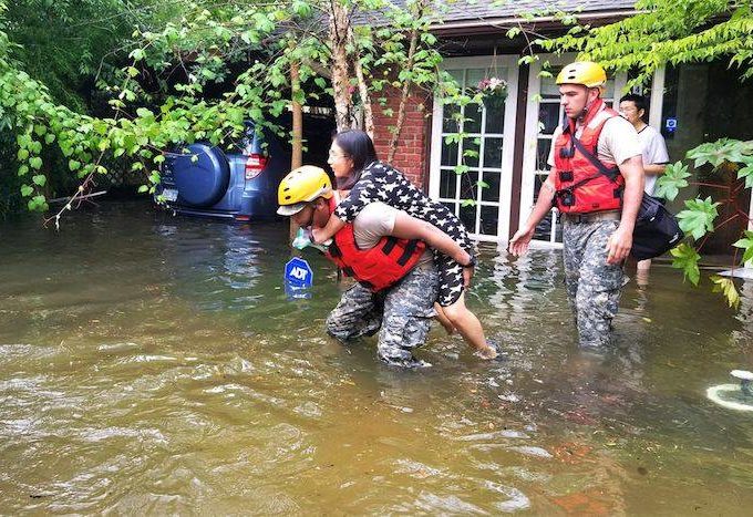 Woman being rescued from her home in Houston.